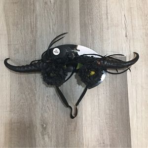 Black voodoo horns with faux flowers and bird skull.